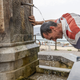 A man refreshes himself in a fountain during a hot summer day in Messina, Italy, on August 11, 2021.